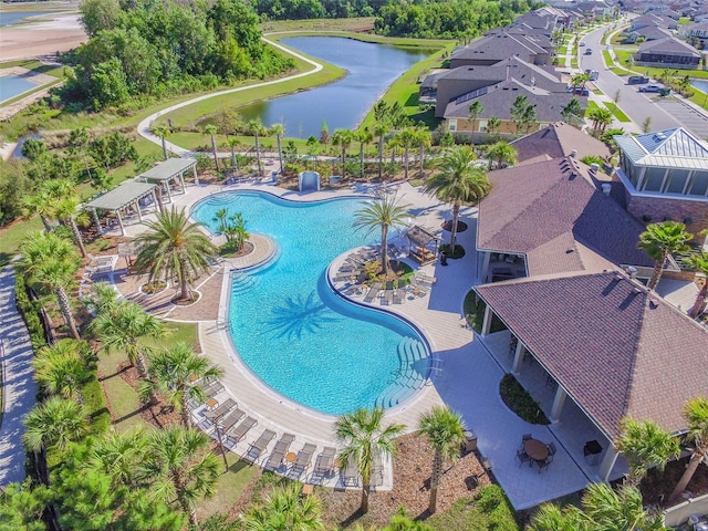 pool featuring a patio and a water view