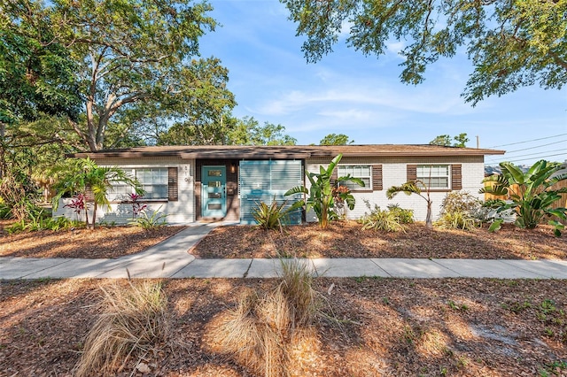 single story home featuring brick siding