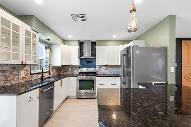 810 22nd St N, Saint Petersburg, FL 33713 - kitchen with visible vents, appliances with stainless steel finishes, glass insert cabinets, a sink, and wall chimney range hood