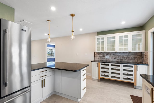 810 22nd St N, Saint Petersburg, FL 33713 - kitchen with visible vents, light wood-style flooring, backsplash, glass insert cabinets, and high end refrigerator