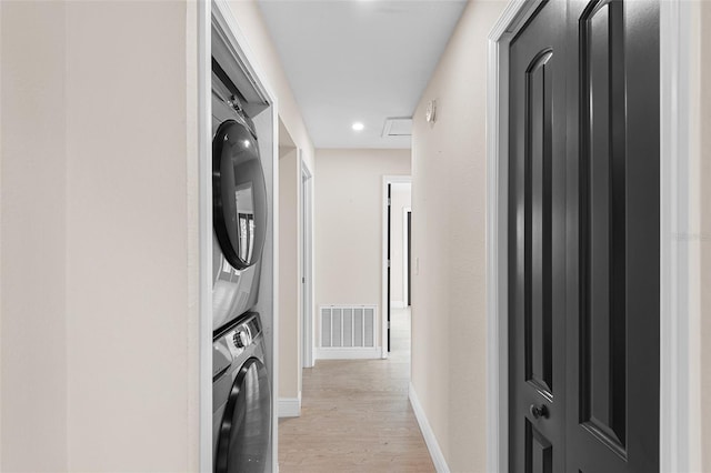 810 22nd St N, Saint Petersburg, FL 33713 - laundry area featuring laundry area, baseboards, visible vents, stacked washer and clothes dryer, and light wood-style floors