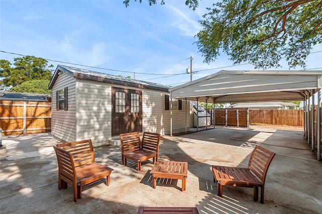 810 22nd St N, Saint Petersburg, FL 33713 - view of patio / terrace with an outbuilding, a fenced backyard, and a detached carport