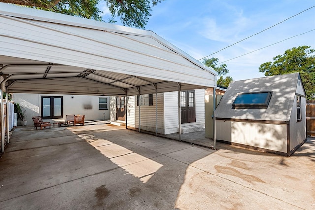 810 22nd St N, Saint Petersburg, FL 33713 - view of car parking with fence, a carport, and french doors