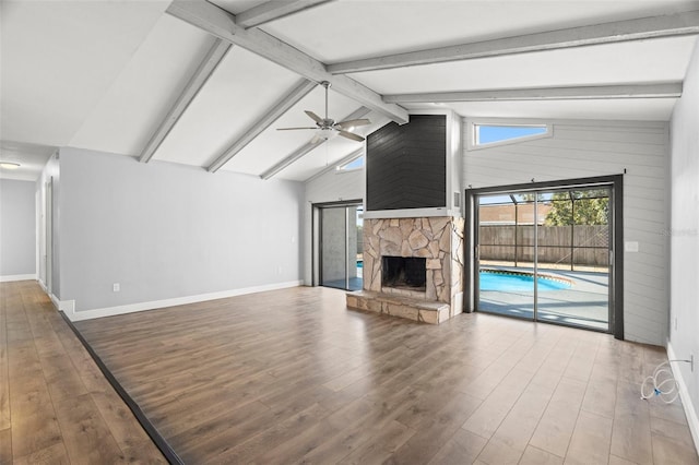 unfurnished living room featuring lofted ceiling with beams, baseboards, a ceiling fan, and wood finished floors