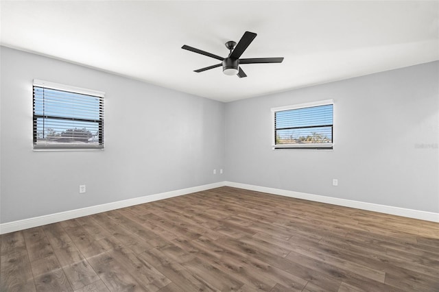 spare room with ceiling fan, baseboards, and wood finished floors