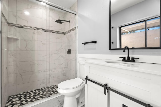 full bath featuring a stall shower, vanity, and toilet