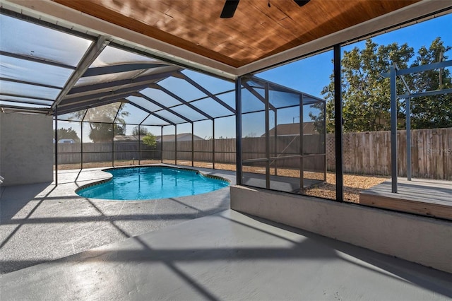 view of pool with a fenced in pool, glass enclosure, a fenced backyard, and a patio