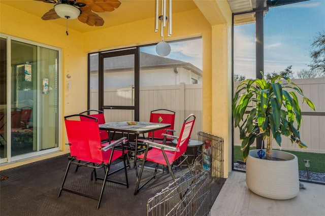 sunroom featuring ceiling fan