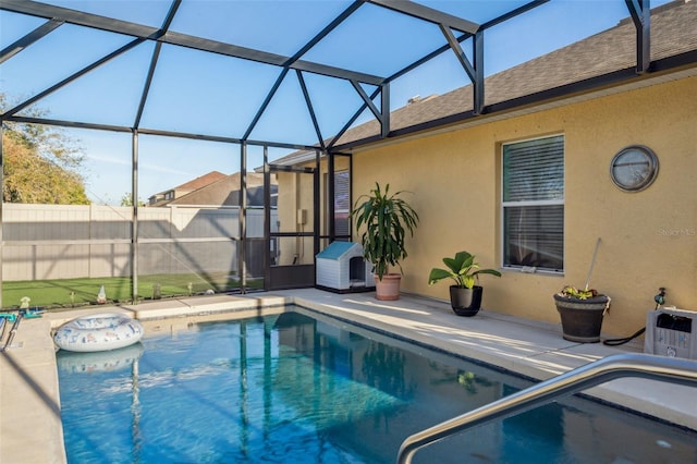 view of pool featuring a lanai, fence, a fenced in pool, and a patio