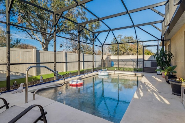 view of pool with a patio area, a fenced backyard, and a lanai