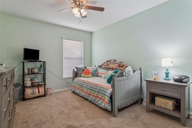 bedroom featuring carpet, a ceiling fan, and baseboards
