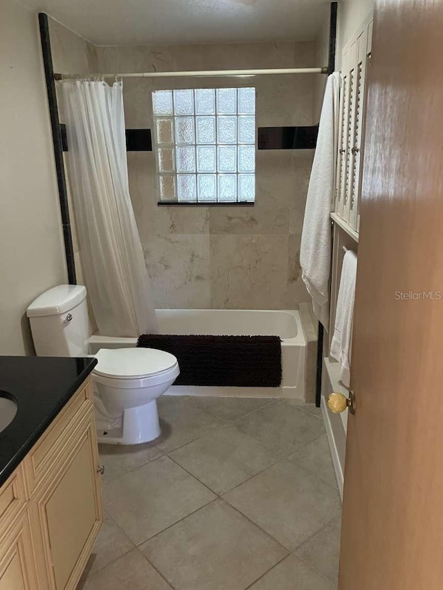 bathroom featuring shower / bath combo, vanity, toilet, and tile patterned floors