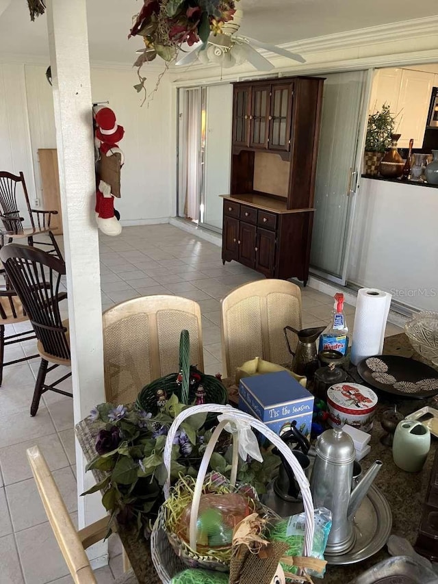 dining area with light tile patterned floors, ceiling fan, and ornamental molding