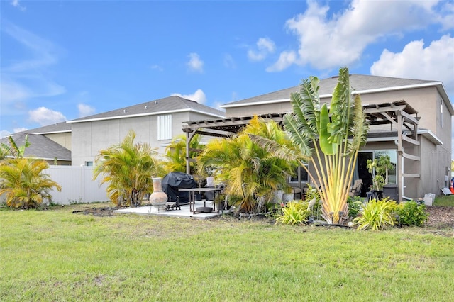 back of property featuring a patio, fence, a lawn, stucco siding, and a pergola