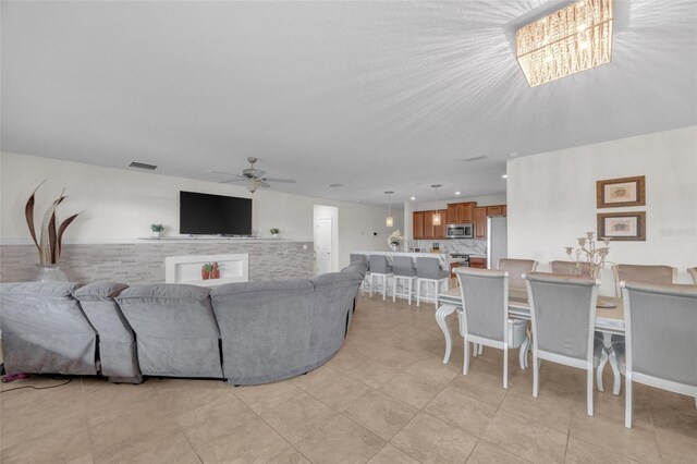 living room with a ceiling fan, recessed lighting, visible vents, and light tile patterned floors