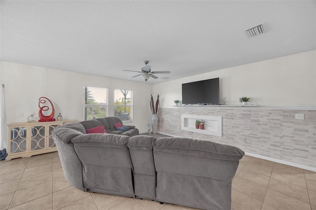 living room featuring light tile patterned floors, ceiling fan, and visible vents