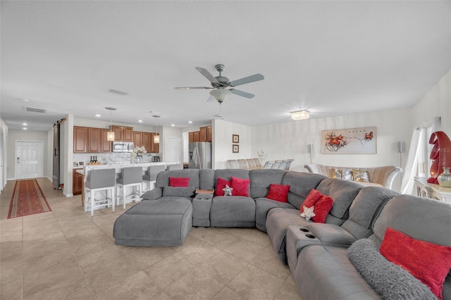 living area featuring ceiling fan, light tile patterned floors, visible vents, and recessed lighting