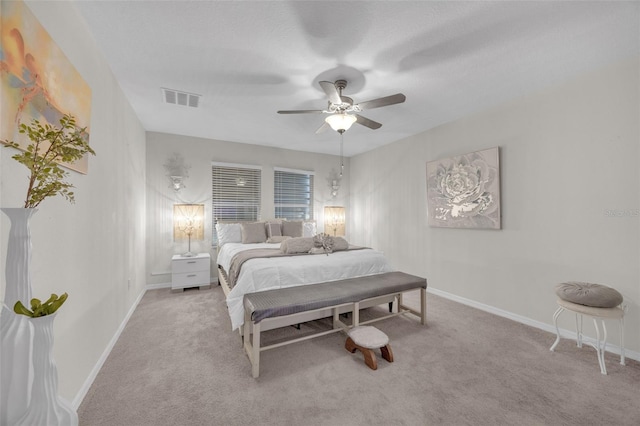 bedroom with baseboards, ceiling fan, visible vents, and light colored carpet