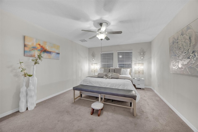 carpeted bedroom with ceiling fan, visible vents, and baseboards