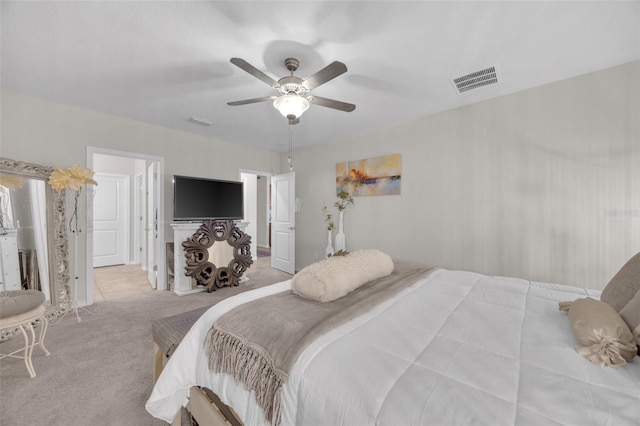 carpeted bedroom featuring ceiling fan and visible vents