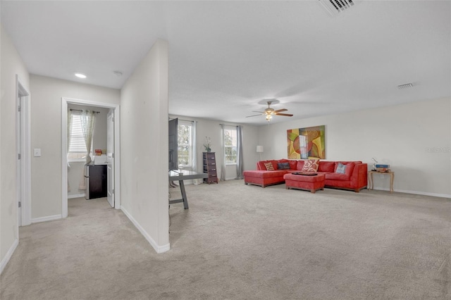 living room featuring carpet, visible vents, and baseboards