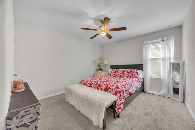 carpeted bedroom with a ceiling fan and baseboards