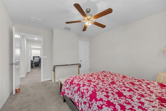 carpeted bedroom with visible vents, ceiling fan, and baseboards