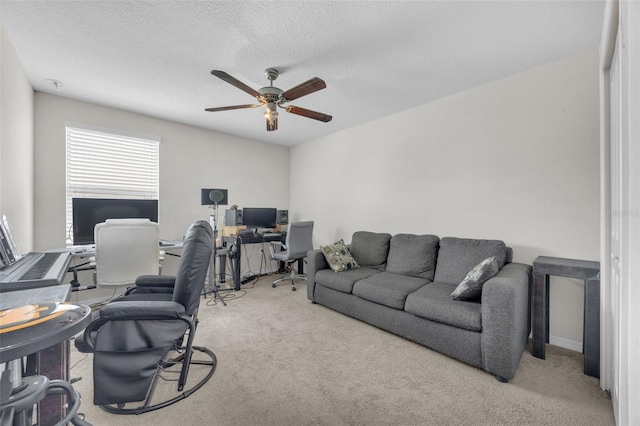 carpeted office with ceiling fan and a textured ceiling