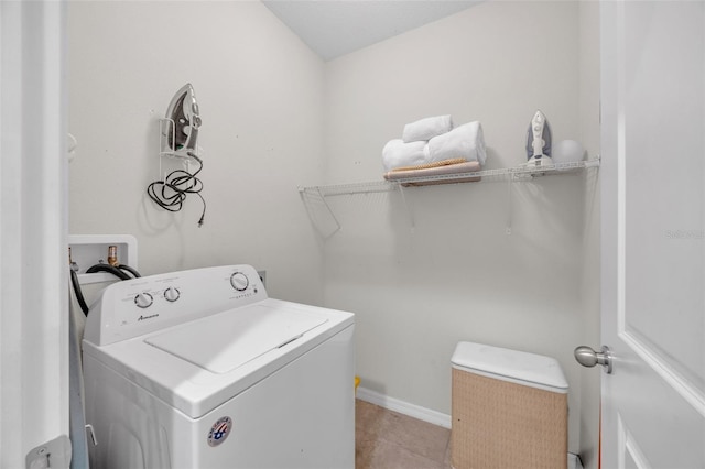 laundry area with washer / dryer, baseboards, light tile patterned floors, and laundry area