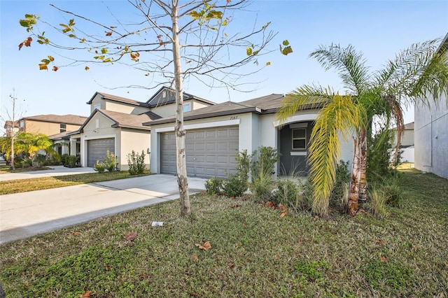 view of front facade with driveway, a garage, and stucco siding