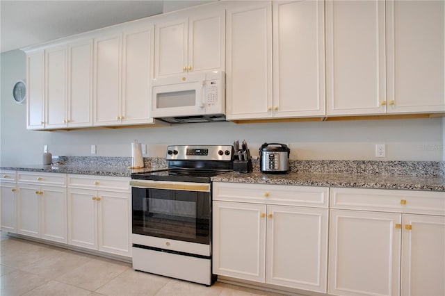 kitchen with white cabinetry, electric range, light stone counters, and white microwave