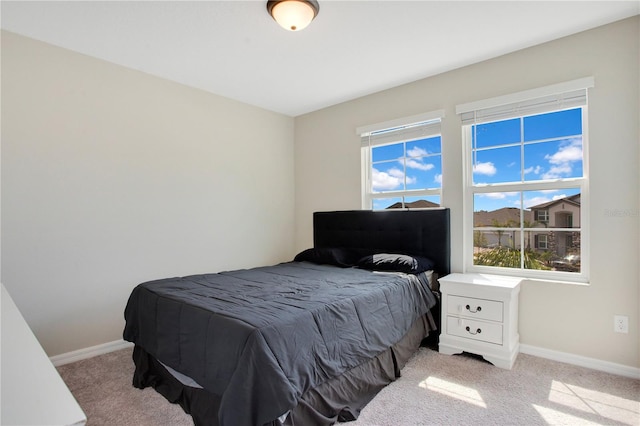 carpeted bedroom featuring baseboards