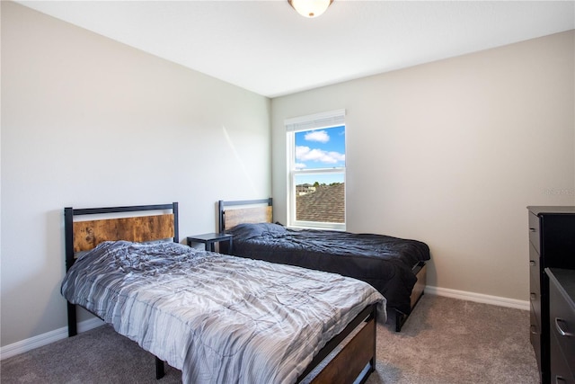 bedroom featuring baseboards and carpet