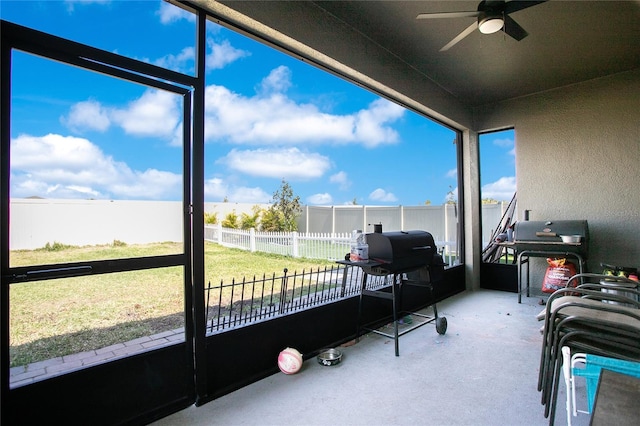 sunroom / solarium featuring ceiling fan