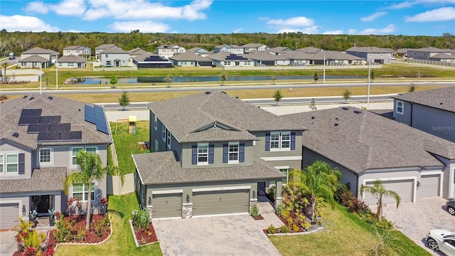 drone / aerial view featuring a residential view and a water view