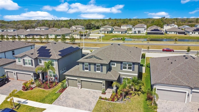 birds eye view of property with a residential view and a water view