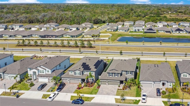 birds eye view of property with a residential view and a water view