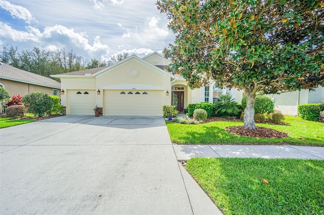 view of front of house featuring concrete driveway, a front lawn, an attached garage, and stucco siding