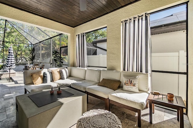 view of patio with glass enclosure and an outdoor hangout area