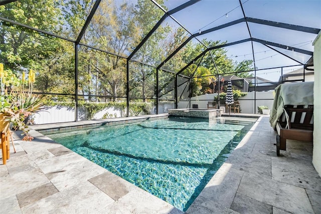 view of pool featuring glass enclosure, a patio, fence, and a pool with connected hot tub