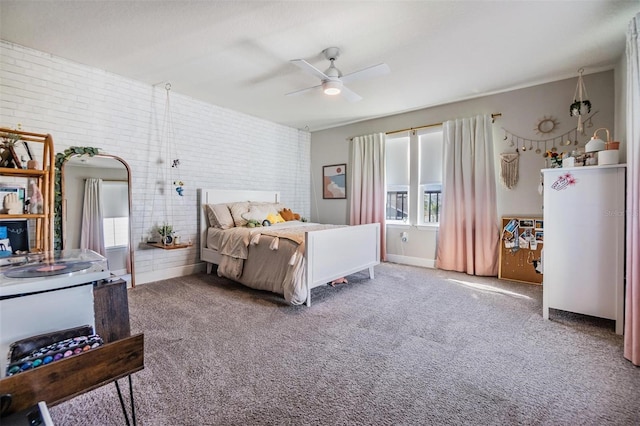 carpeted bedroom featuring brick wall and a ceiling fan