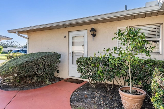 entrance to property with stucco siding