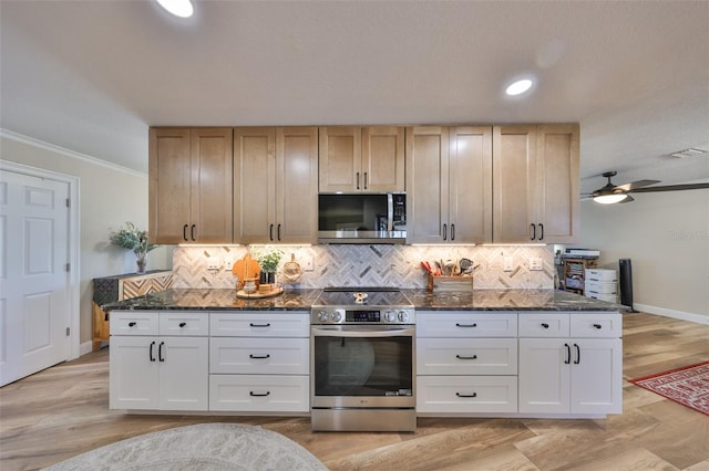 kitchen featuring dark stone countertops, backsplash, appliances with stainless steel finishes, and ornamental molding