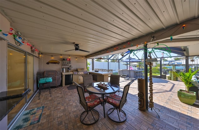 view of patio featuring outdoor dining space, a lanai, and ceiling fan
