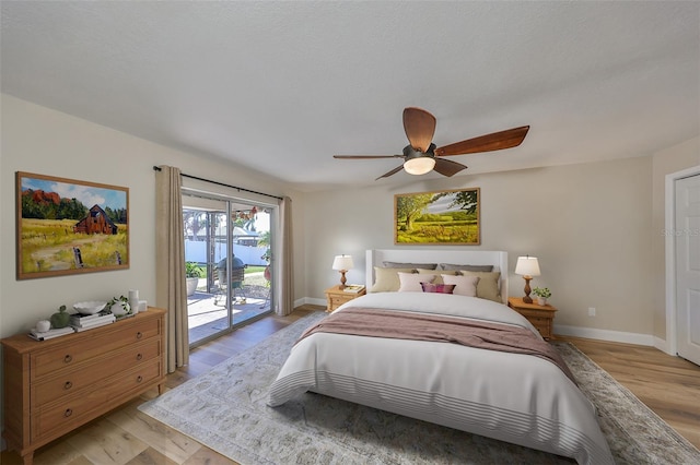 bedroom featuring light wood-type flooring, baseboards, and access to outside