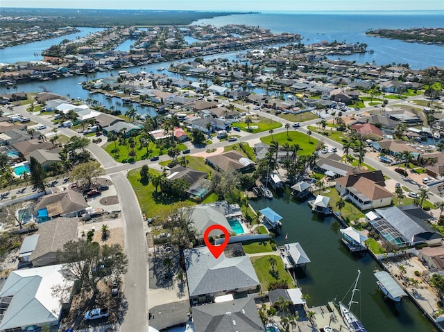 birds eye view of property with a residential view and a water view