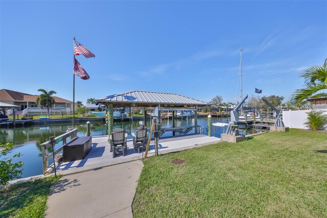 dock area featuring a yard, a water view, and boat lift