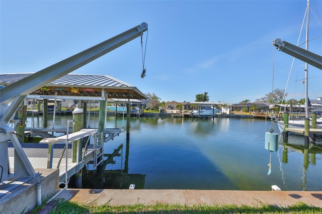 view of dock with boat lift and a water view