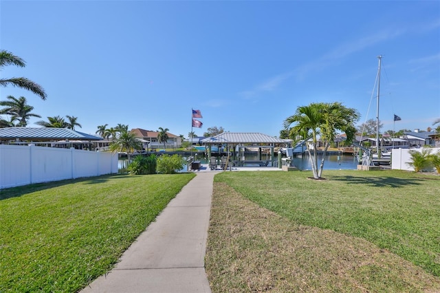 exterior space featuring fence and a water view