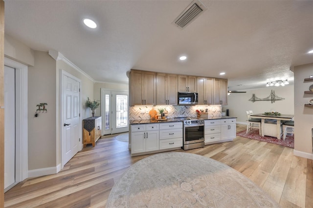 kitchen with visible vents, stainless steel range with electric cooktop, light wood-style floors, dark countertops, and backsplash